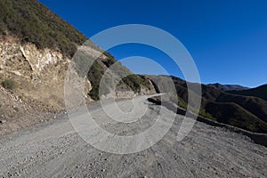 dirth road and footprint in the andes mountain range mendoza argentina