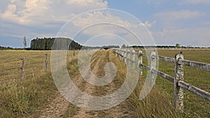 Dirtroad between meadows and fields in the wallonian countryside.