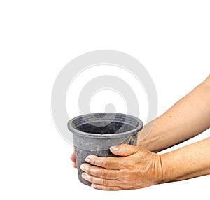 Dirty black empty plastic flowerpot with old aged holding on white