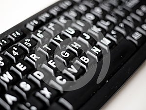 Dirty black keyboard macro, front and back background blurred