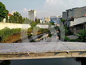 Dirty black river atmosphere with high rise building background