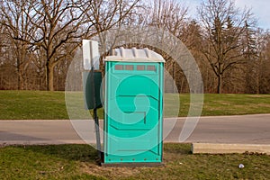 A Dirty, Blue Portable Toilet in a Park, nasty looking place to photo