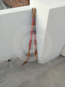 Dirty broken broom stand on terrace