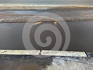 dirty bus stop in early spring with melted snow. bus stop borders.