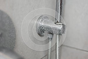 Dirty calcified shower mixer tap, faucet with limescale on it, plaque from hard water, Chrome plated shower, close up