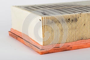 Dirty car air filter on a white background, isolate. The concept of replacing the filter element according to the car maintenance