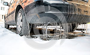 Dirty car with icicles on bumber