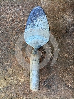 Dirty cement spoon with hardened cement residue