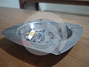 Dirty cigarette ashtray on the table