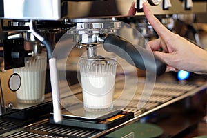 Dirty Coffee - Coffee machine pours espresso shot into a glass of cold fresh milk