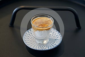 Dirty Coffee - A glass of espresso shot mixed with cold fresh milk on blurred background and copy space.