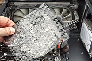 Dirty computer case. A layer of dust on the system unit. Time to clear your computer of dust. Dusty mesh from the