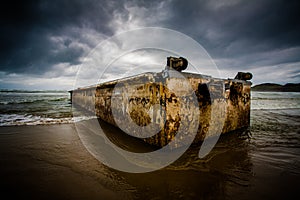 Dirty concrete box washed ashore