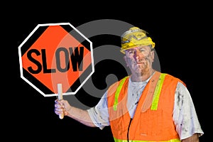 Dirty construction worker holding slow sign