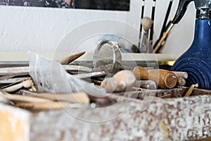 Dirty craft sculpting tools in pottery workshop