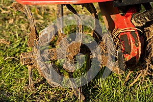 Dirty cultivator blades close-up. Tilling the land on the farm. Farming.
