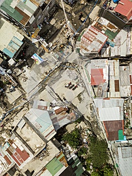 A dirty and depressed area in Las Pinas. Spaghetti wires, corrugated metal roofs and a few motorcycles