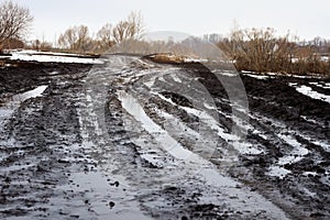 Dirty dirt road with big ditches