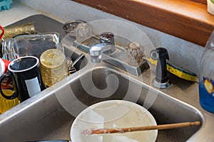 dirty dishes in old sink at vintage farmhouse