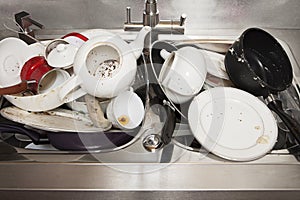 Dirty dishes on sink in the kitchen photo