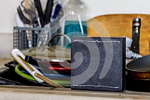 Dirty Dishes in sink with sign