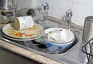 Dirty dishes in a sink for washing up. photo