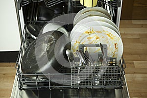 Dirty dishware in dishwasher photo