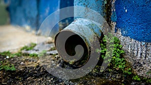 Dirty drainage system tube on facade of the building. Water drain from the roof to the gutter