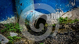 Dirty drainage system tube on facade of the building. Water drain from the roof to the gutter