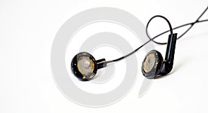 dirty and dusty used black ear buds  on white background