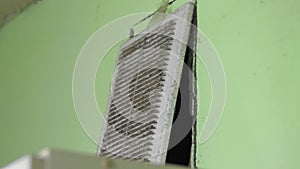 Dirty and dusty ventilation shaft plastic grate in the home kitchen. Allergy. Poverty destitution misery concept