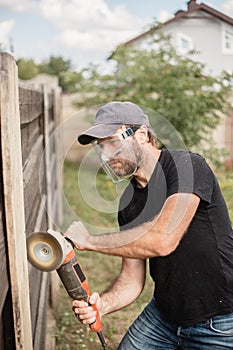 Dirty and dusty work with a sanding disc on wood