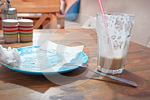 Dirty empty plate and half-empty glass of coffee