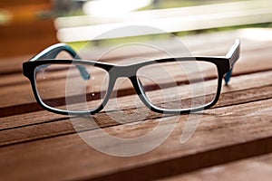 Dirty eyeglasses, presciption glasses, on display, with several spots, marks and fingerprints traces, that need to be cleaned