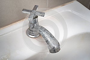 Dirty faucet with stain and limescale