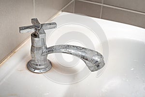 Dirty faucet with stain and limescale