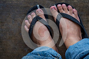 Dirty feet of a man wearing sandal