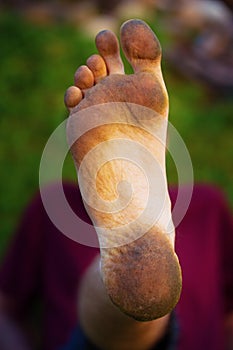 Dirty foot man on green background.