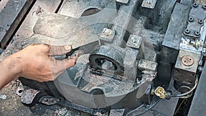 A machine being cleaned by a mechanic photo