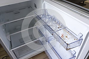Dirty fridge with open door.
