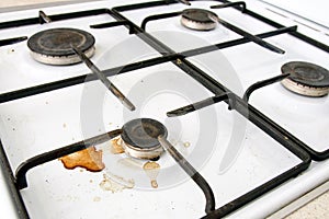 Dirty gas stove burners in kitchen room after cooking