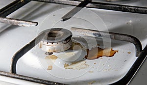 Dirty gas stove burners in kitchen room after cooking