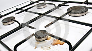 Dirty gas stove burners in kitchen room after cooking