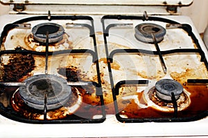 Dirty gas stove. Fat, rust on the surface.