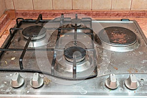 Dirty gas stove in grease stains burners in kitchen room