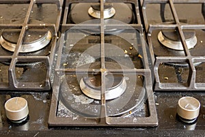 Dirty glass-ceramic gas hob. Drenched in fat and broth black hob.