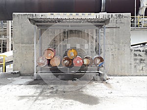 Dirty greasy barrels outside building with grease barrels.