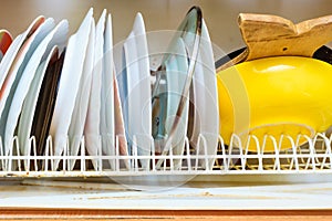 Dirty grubby drainer with clean dishes in kitchen.