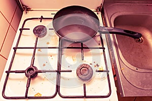 Dirty grubby gas stove in kitchen