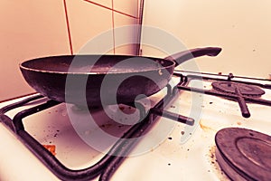 Dirty grubby gas stove in kitchen